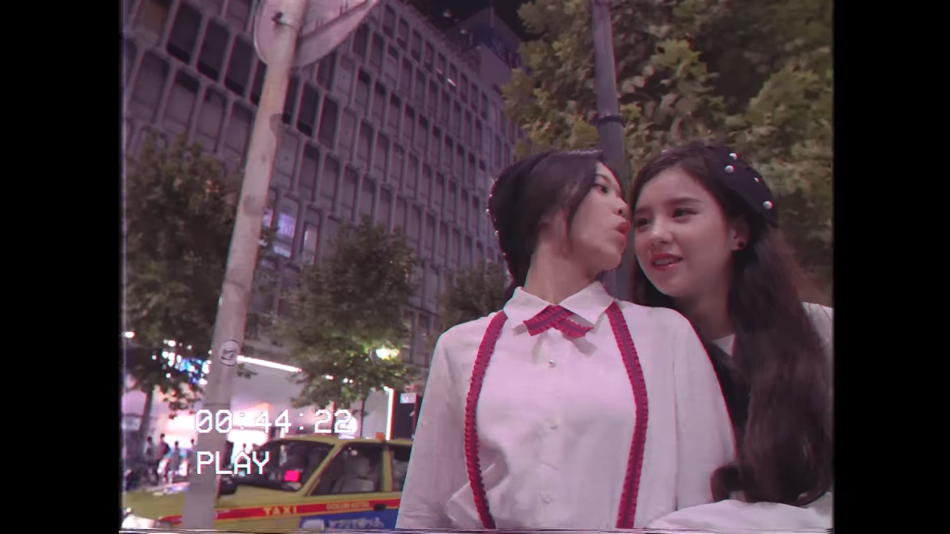 Hyunjin pretending to kiss Heejin on the cheek.